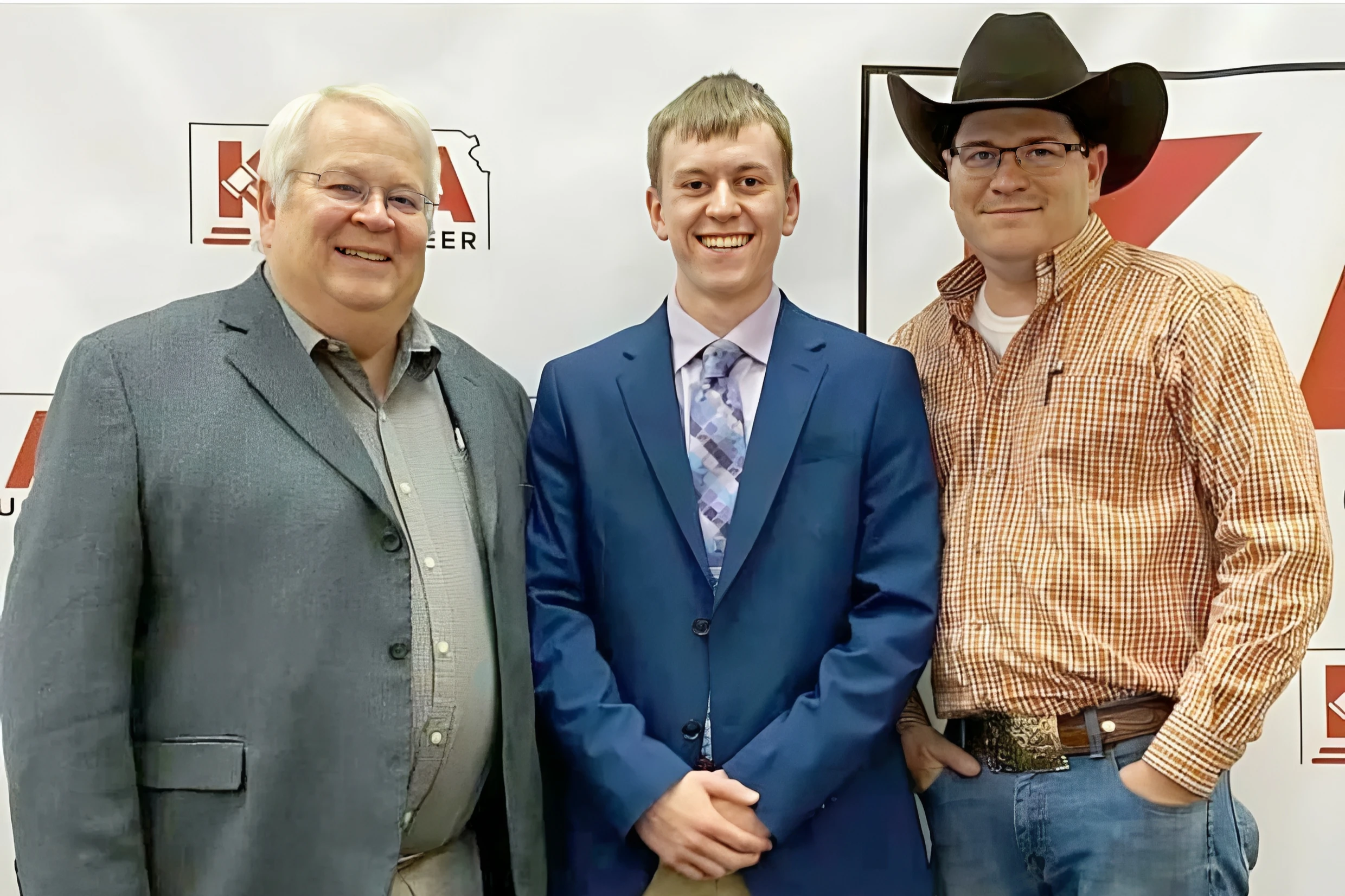 Three men smiling at an event