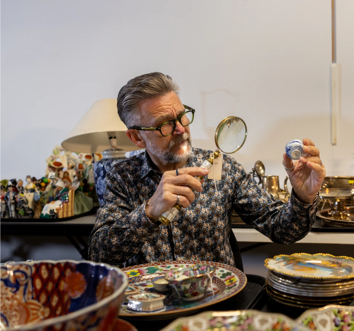 Person studying decorative object in store