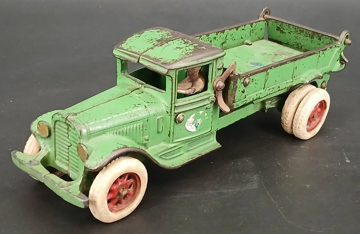 Old green metal toy truck with white wheels